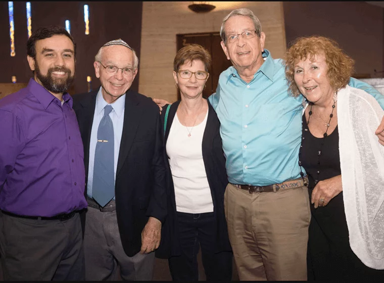 multi generational group of adults posing at social event