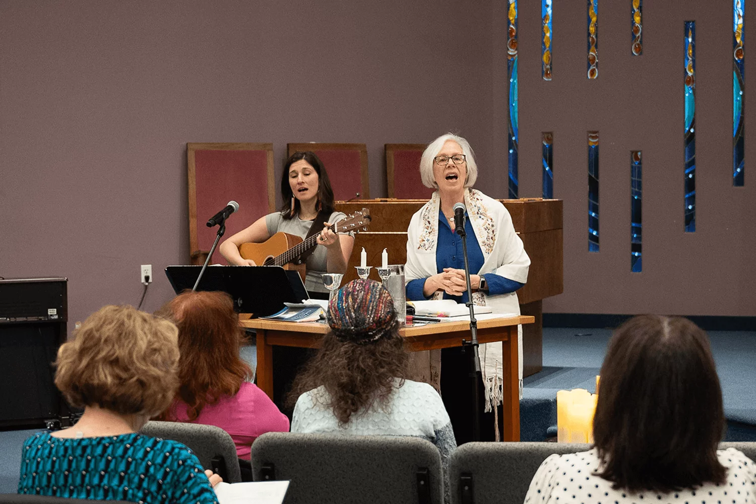 rabbi perry and ariel strasser leading shabbat service