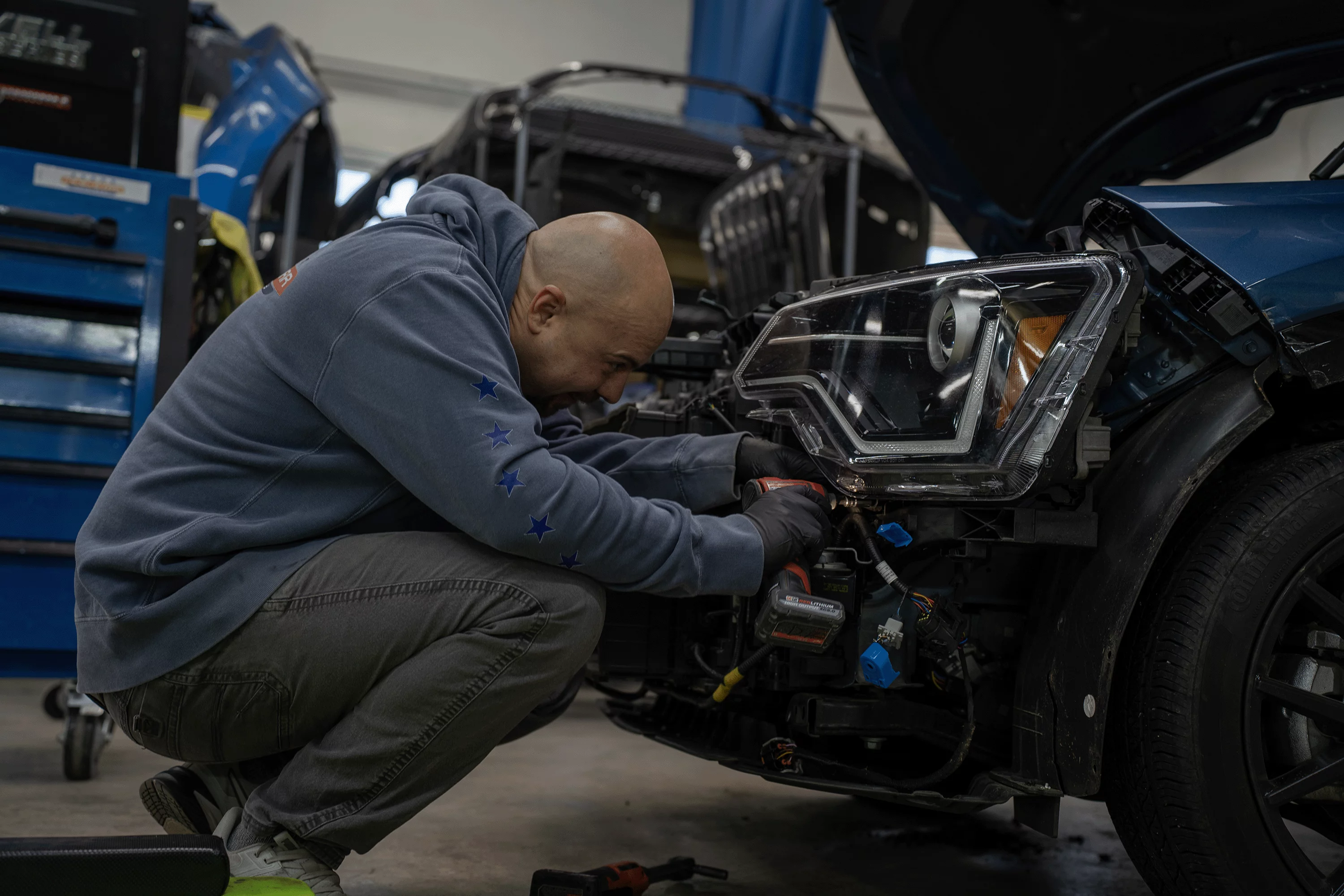 Headlight assembly removal during collision structural repair at Five Star Auto Body