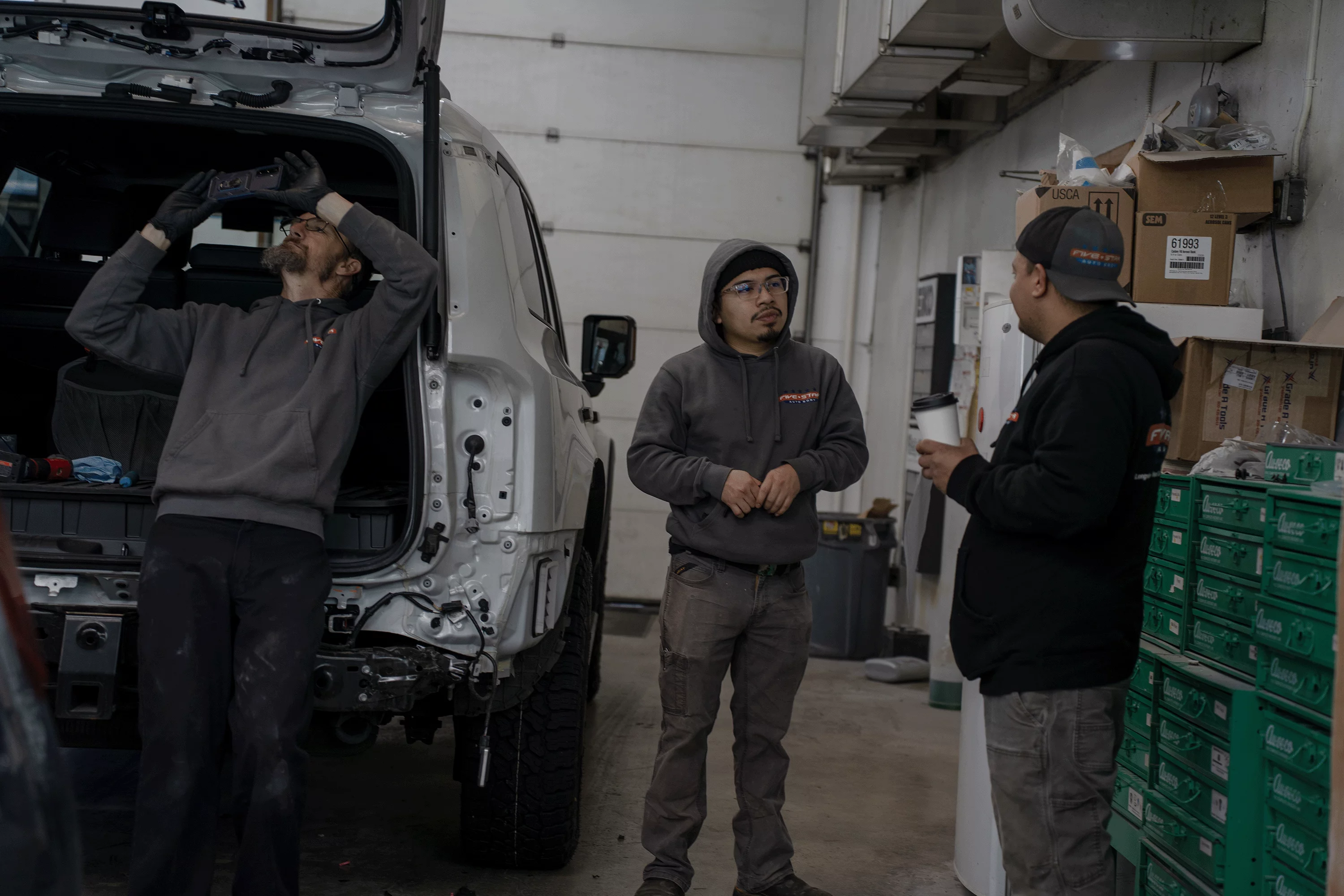 Staff in service bay ready to assist with email inquiries