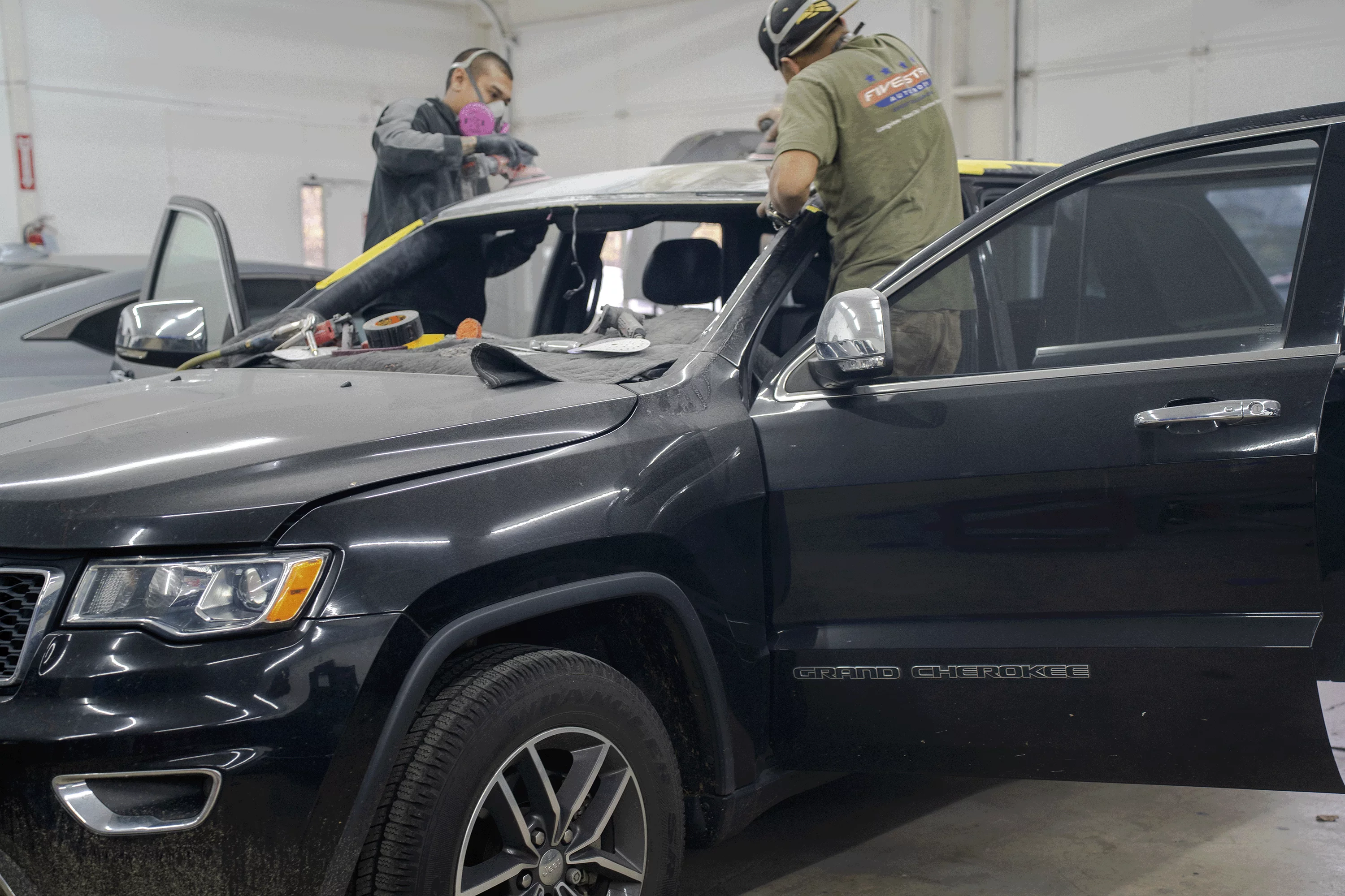 Five Star Auto Body team collaborating on a vehicle repair project