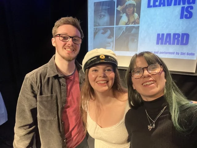 A selfie with Billie-Jo Rainbird standing on the right, Siri Bolin in the centre, in a costume of a white dress and Swedish graduation hat, and her fiancé Owen on the left.