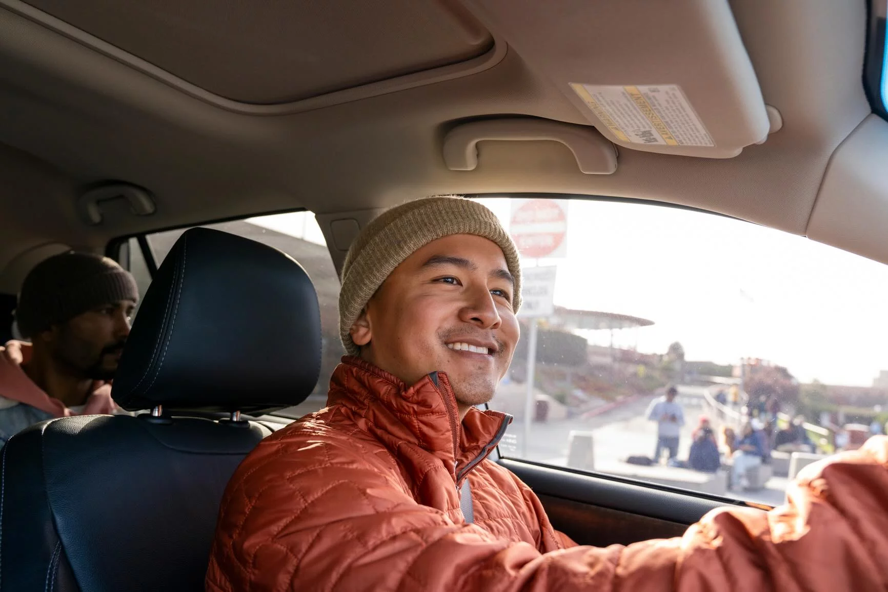 Omni driver behind the wheel of a Tesla Model 3