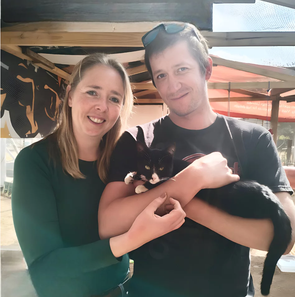 Adoption twelve: Cat. A new married couple adopted a Tuxedo cat. Even though the cat is small it is fully grown and not a kitten. The couple is very happy about the cat. Both the new cat parents are happy about their decision to adopt.