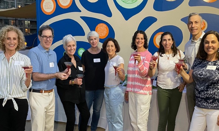 group of empty nesters at a rooftop cocktail party
