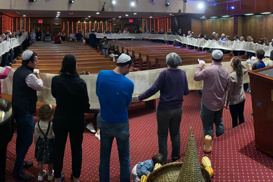 Community Uunrolling the Torah Scroll in the Sanctuary on Simchat Torah