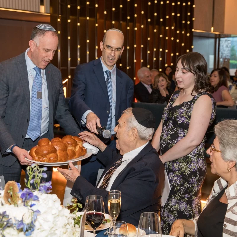 shaaray tefila clergy doing the motzi at gala event
