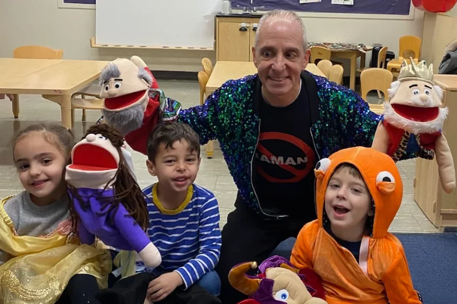 Religious School students having fun with puppets in the classroom