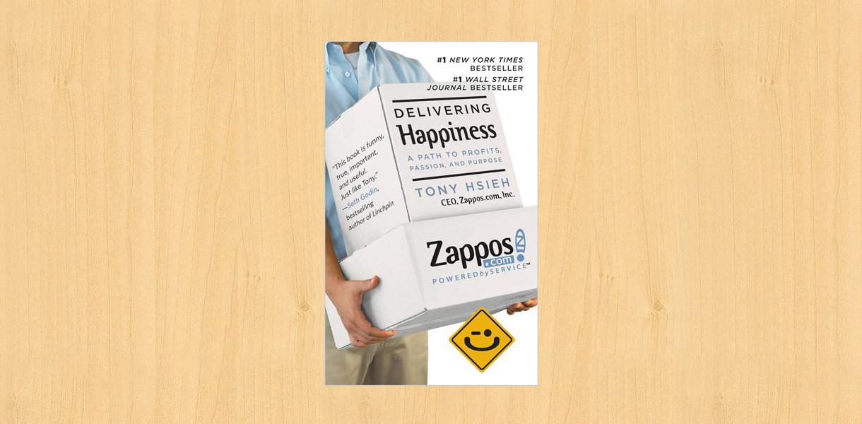 Delivering happiness book placed on the desk.